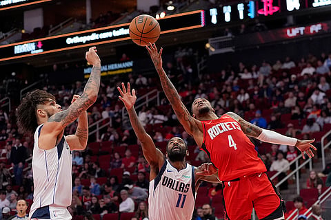 NBA 2024-25: Rockets' Jalen Green (4) shoots as Mavericks' Kyrie Irving (11) and Dereck Lively II defend