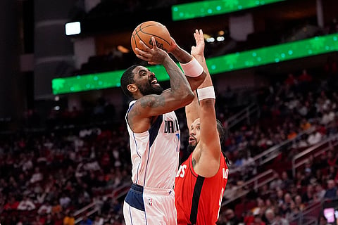 NBA 2024-25: Mavericks' Kyrie Irving, left, shoots as Rockets' Dillon Brooks defends