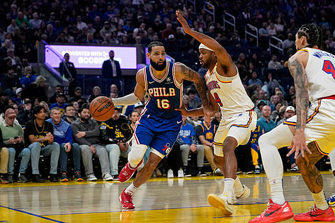 NBA 2024-25: 76ers forward Caleb Martin moves the ball while defended by Warriors guard Moses Moody