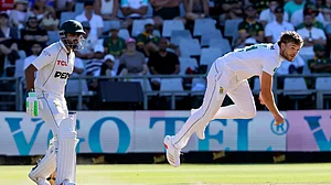 AP Photo/Halden Krog : Pakistan's Babar Azam watches as South Africa's Wiaan Mulder bowls during the second day of the second test match between South Africa and Pakistan in Cape Town.