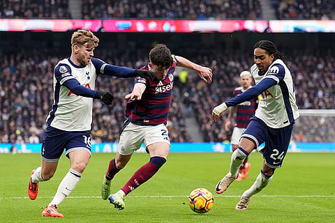 EPL 2024-25: Newcastle United's Tino Livramento battles for the ball with Tottenham players