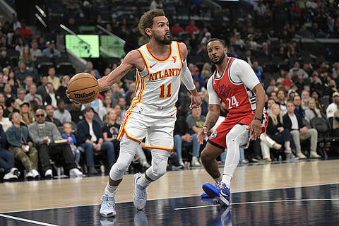 NBA 2024-25: Hawks guard Trae Young, left, is defended by Clippers guard Norman Powell 