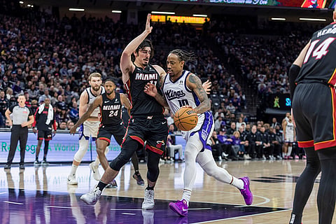 NBA 2024-25: Kings forward DeMar DeRozan, right, drives to the basket with Heat guard Jaime Jaquez Jr. 