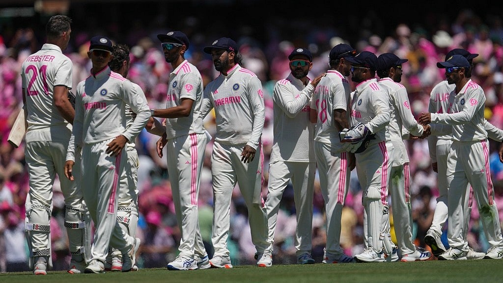 Australian and Indian players shake hands after the fifth Test at the Sydney Cricket Ground. - AP