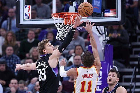 NBA 2024-25: Jazz forward Lauri Markkanen (23) blocks the shot of Hawks guard Trae Young
