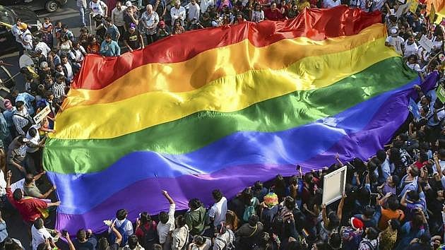 LGBTQ community people waving rainbow flag