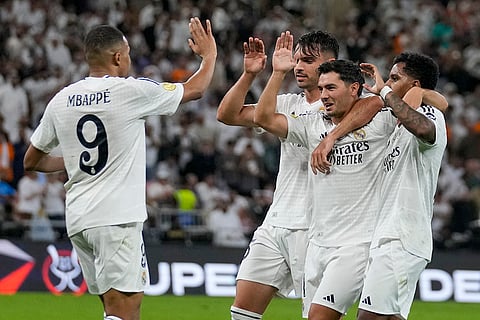 Spanish Super Cup: Real Madrid players celebrate after Mallorca's Martin Valjent scored an own goal 