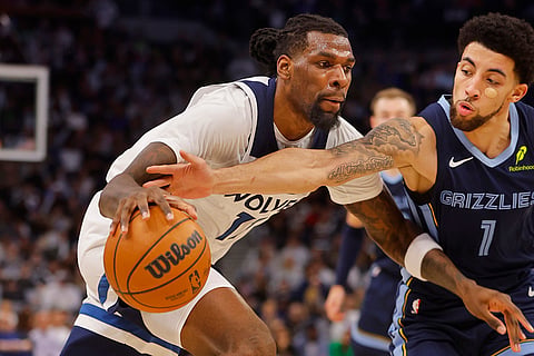 NBA 2024-25: Timberwolves center Naz Reid goes to the basket against Grizzlies guard Scotty Pippen Jr. 