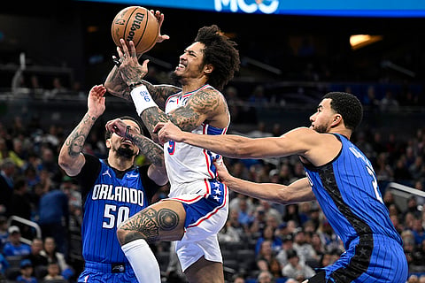 NBA 2024-25: 76ers guard Kelly Oubre Jr. (9) is fouled by Magic guard Caleb Houstan