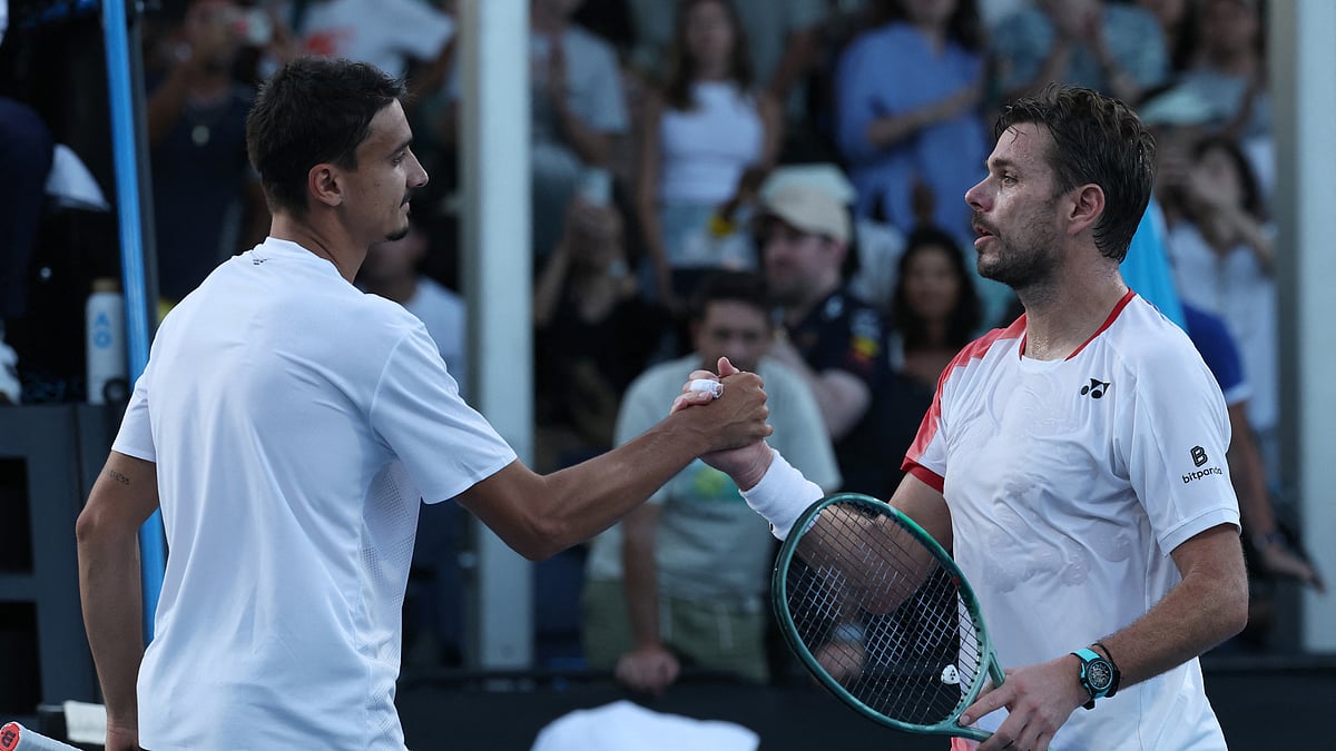 Lorenzo Sonego and Stan Wawrinka shake hands after their match at the Australian Open.