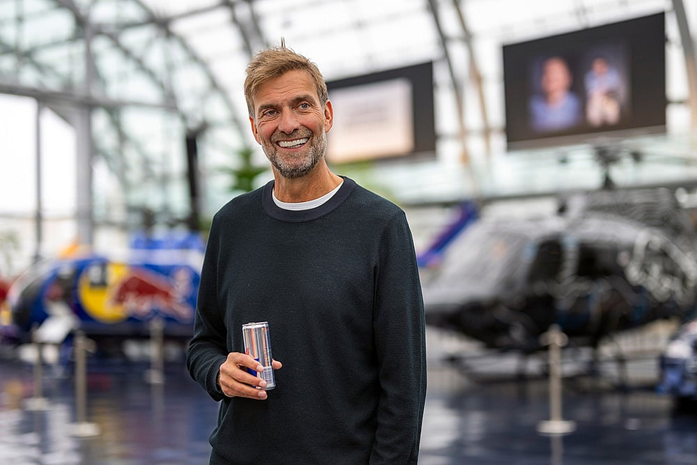 Jurgen Klopp Poses With Red Bull F1 cars in Salzburg