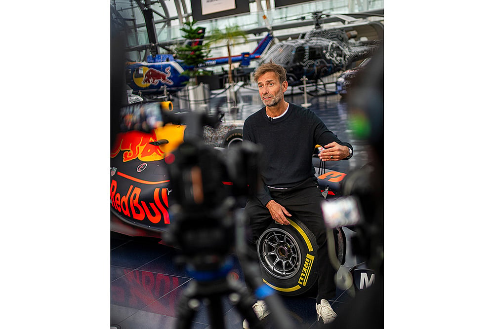Jurgen Klopp Poses With Red Bull F1 cars in Salzburg