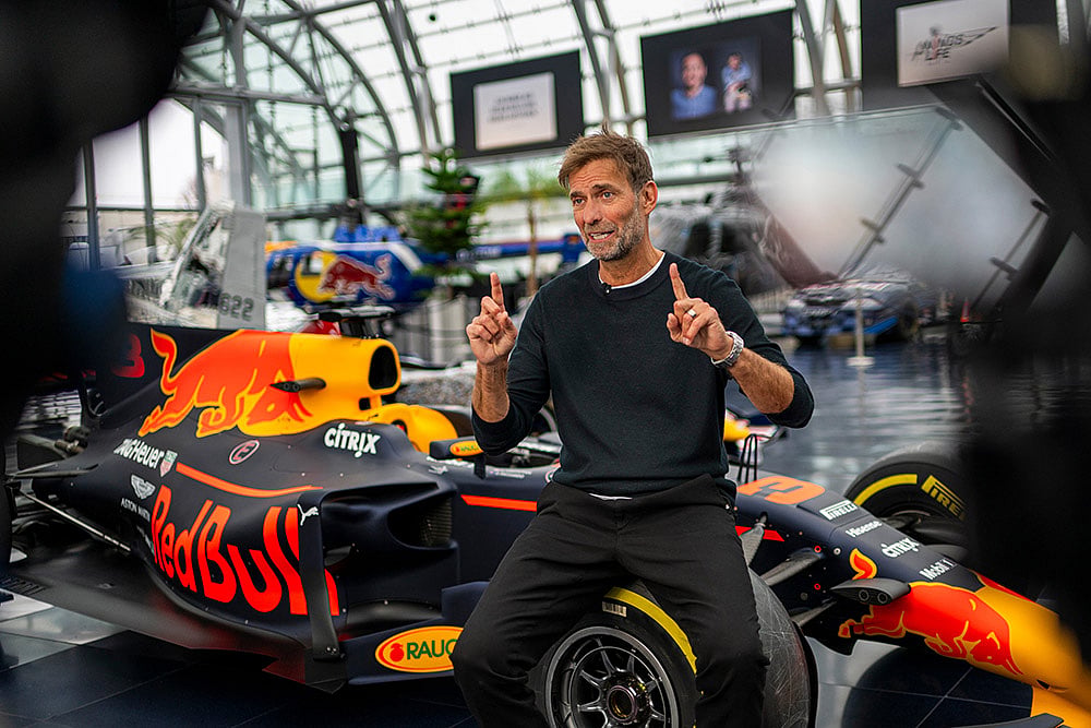 Jurgen Klopp Poses With Red Bull F1 cars in Salzburg