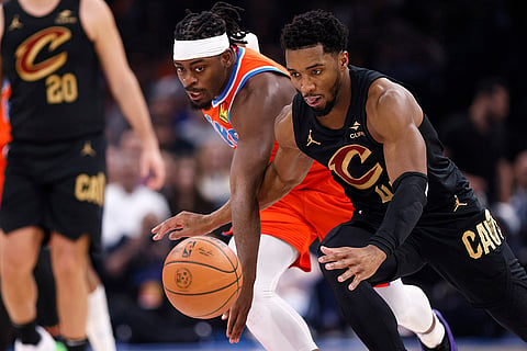 NBA 2024-25:  Thunder guard Luguentz Dort and Cavaliers guard Donovan Mitchell, right, chase the ball 