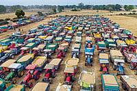 Where Is India's Farming Sector Headed? | Photo: PTI : The Agony of Waiting: Farmers line up their tractors with wheat grain at a wholesale market in Jabalpur