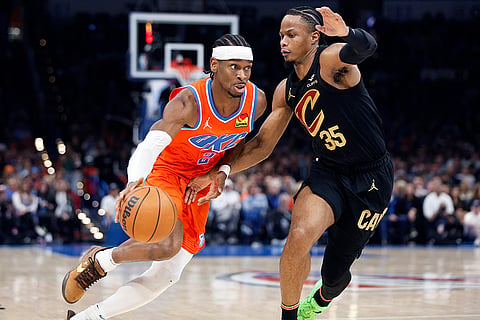NBA 2024-25: Thunder guard Shai Gilgeous-Alexander (2) drives against Cavaliers forward Isaac Okoro