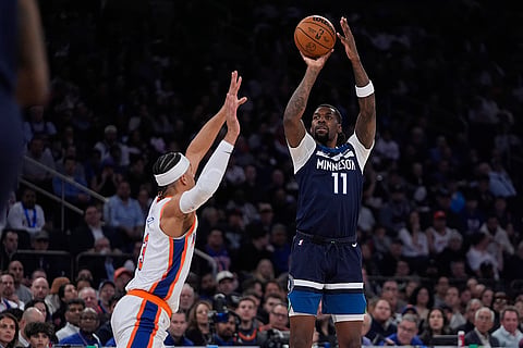 NBA 2024-25: Timberwolves' Naz Reid (11) shoots over Knicks' Josh Hart 