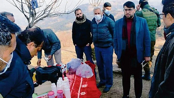Senior officials carry out an inspection at Badhaal village in Rajouri district.