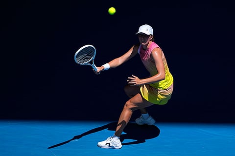 Australian Open 2025:  Iga Swiatek plays a forehand return to Emma Navarro
