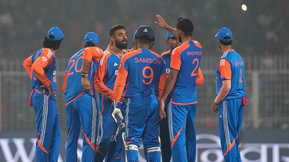 Indias Varun Chakravarthy, third left, celebrates with teammates. AP Photo