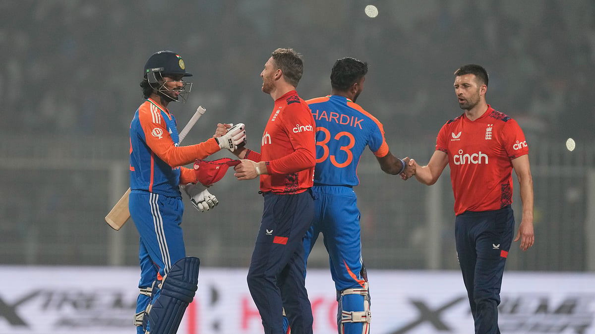 Englands captain Jos Buttler, second left, congratulates. AP Photo