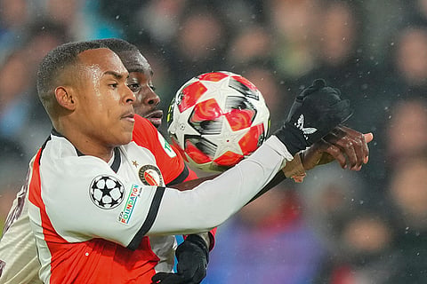 Champions League 2024-25: Feyenoord's Bart Nieuwkoop, front, duels for the ball with Bayern's Alphonso Davies