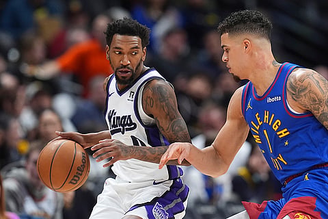 NBA Basketball 2024-25: Kings guard Malik Monk looks to pass the ball as Nuggets Michael Porter Jr. defends