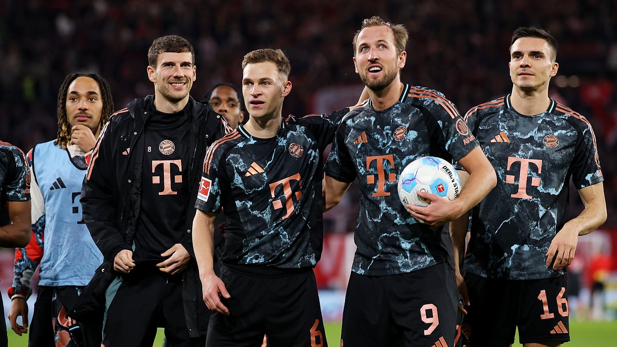 Bayern Munich players celebrate their win away to Freiburg, led by Harry Kane and Joshua Kimmich.
