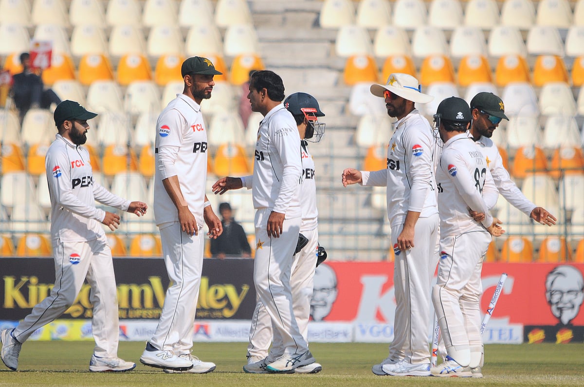 (AP Photo/Asim Tanveer) : Pakistan's Noman Ali, center, celebrates with teammate after taking the wicket of West Indies Mikyle Louis during the day-two of the second cricket test match between Pakistan and West Indies, in Multan, Pakistan, Sunday, Jan. 26, 2025. 