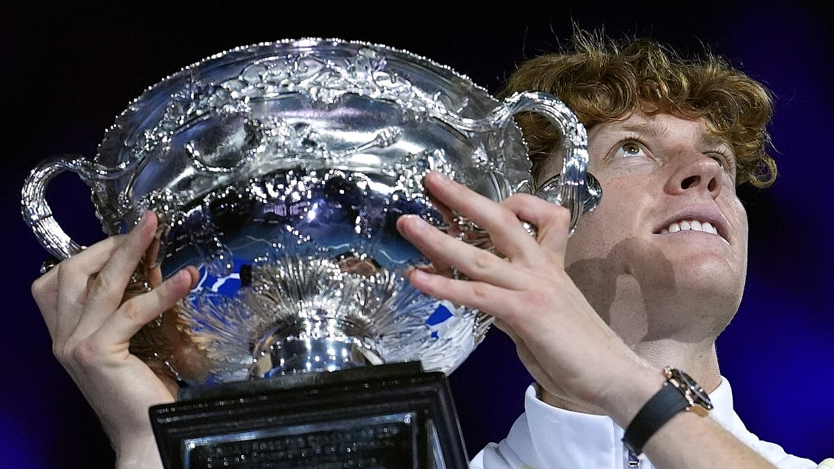 AP Photo/Ng Han Guan : Jannik Sinner of Italy holds the Norman Brookes Challenge Cup aloft after defeating Alexander Zverev of Germany in the men's singles final at the Australian Open tennis championship in Melbourne.