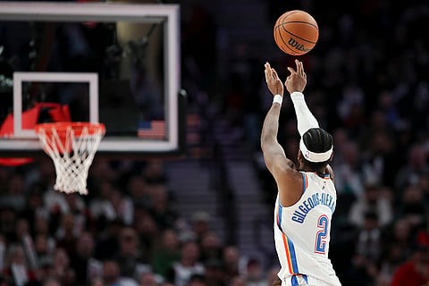 NBA 2024-25: Thunder guard Shai Gilgeous-Alexander (2) shoots against the Portland Trail Blazers