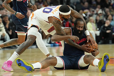 NBA 2024-25: Clippers guard James Harden, right, battles Suns Royce O'Neale, left, for the ball