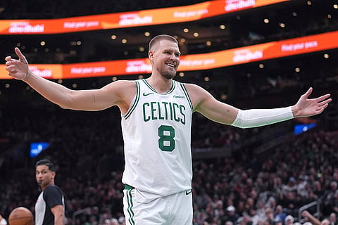 NBA 2024-25: Celtics center Kristaps Porzingis smiles at the crowd 
