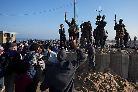 Hamas fighters flash the victory sign