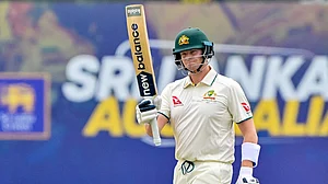 Smith salutes the crowd after notching his 10,000th Test run.