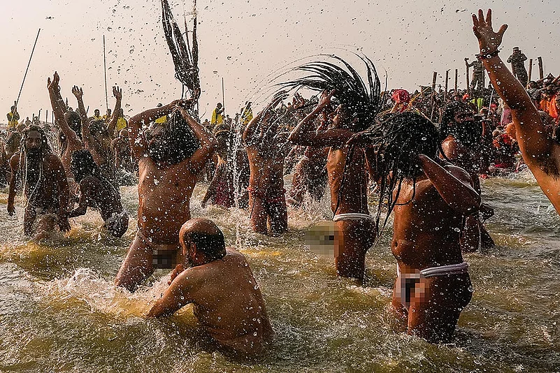 Sadhus take a dip at the Triveni Sangam on the occasion of Mauni Amavasya