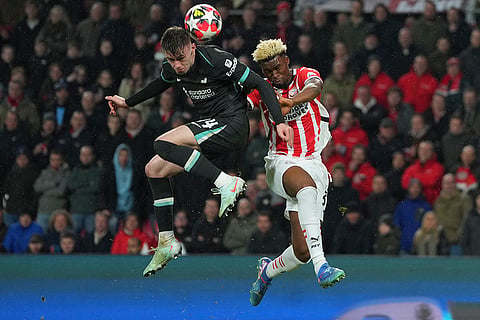 Champions League 2024-25: Liverpool's Conor Bradley and PSV's Adamo Nagalo jump for the ball