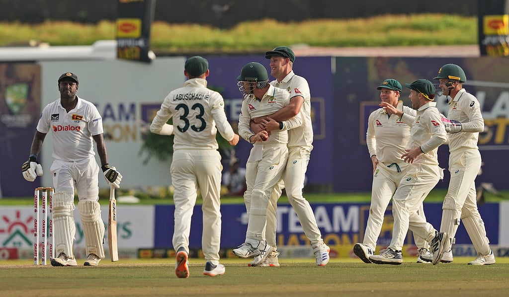 AP : Travis Head celebrates after taking a catch to dismiss Sri Lanka's Angelo Mathews during day two of the first test cricket match.