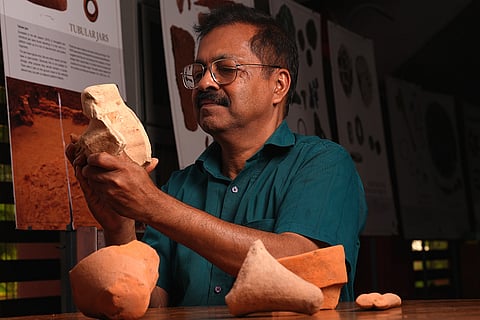 Dr K P Shajan, archaeologist, looking at the artifacts excavated from Pattanam.