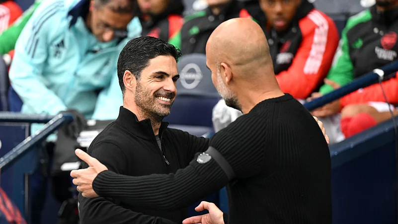 Mikel Arteta and Pep Guardiola embrace at the Etihad Stadium