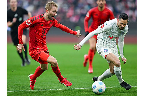 Bundesliga 2024-25: Bayern's Konrad Laimer and Kiel's Steven Skrzybski challenge for the ball