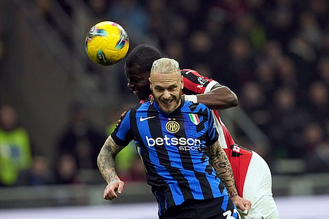 Serie A 2024-25: AC Milan's Yunus Musah, background vies for the ball with Inter Milan's Federico Dimarco