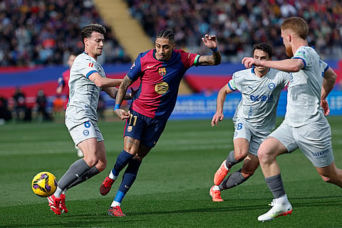 La Liga 2024-25: Barcelona's Raphinha is challenged by Alaves' Antonio Blanco
