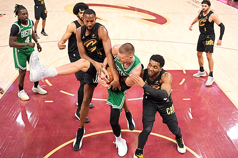 NBA 2024-25: Cavaliers forward Evan Mobley and Donovan Mitchell fight for control of the ball