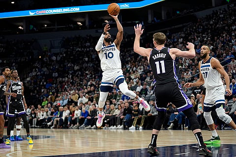 NBA 2024-25: Timberwolves guard Mike Conley (10) goes up to shoot 