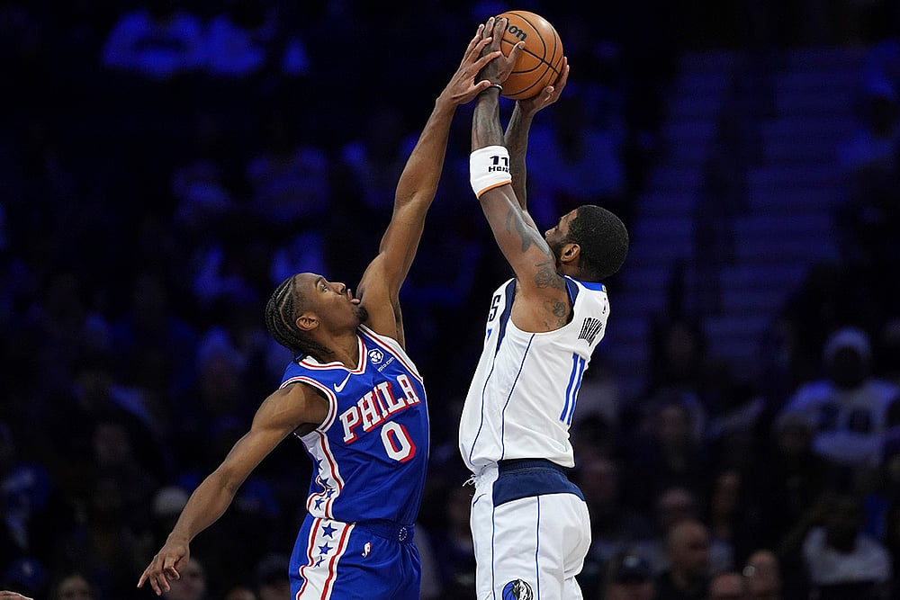 | Photo: AP/Matt Slocum : NBA 2024-25: Mavericks' Kyrie Irving, right, cannot get a shot past 76ers' Tyrese Maxey