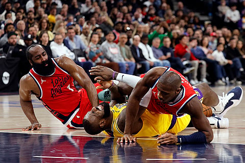 NBA 2024-25: Lakers forward LeBron James falls to the ground with Clippers Kris Dunn and James Harden