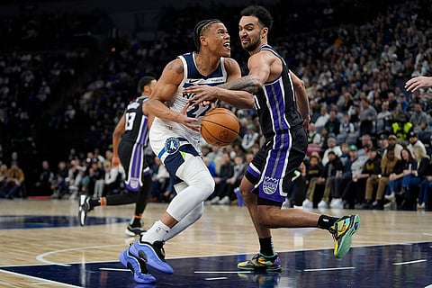 NBA 2024-25: Timberwolves Jaylen Clark loses control of the ball as Kings Trey Lyles defends 