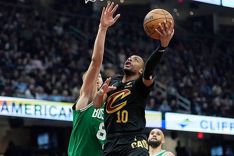 NBA 2024-25: Cavaliers guard Darius Garland (10) shoots in front of Celtics center Kristaps Porzingis