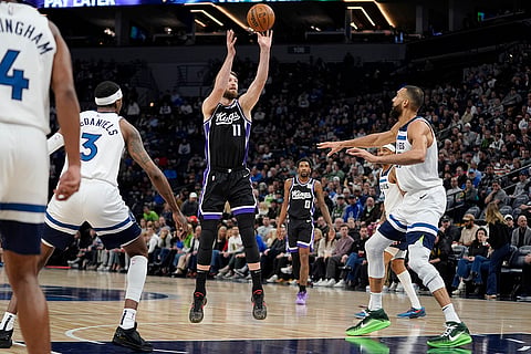 NBA 2024-25: Kings forward Domantas Sabonis (11) shoots over Timberwolves center Rudy Gobert